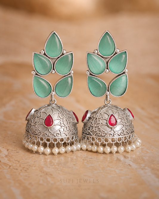 The Dew Found Drops silver-look jhumka earrings with mint teardrop stones and white pearl drops.