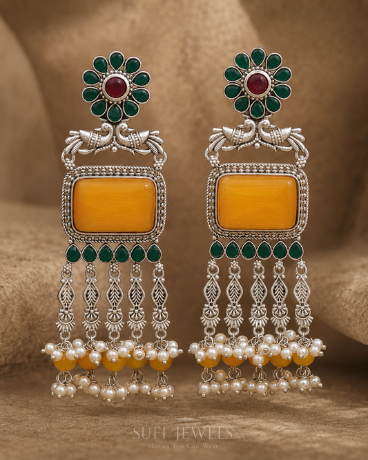 The Sun Escaped Evening silver-look dangler earrings with yellow and green stones and cascading pearl accents.