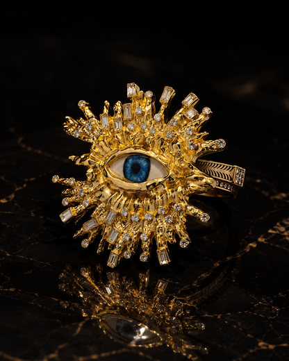 The Eye Saw Everything oversized gold-tone statement ring with vivid blue eye and crystal-look accents by The House of SUFI.