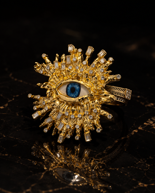 The Eye Saw Everything oversized gold-tone statement ring with vivid blue eye and crystal-look accents by The House of SUFI.